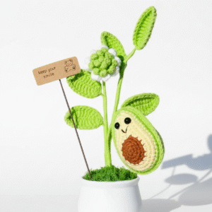 crocheted avocado plant with smiley face and green leaves cute home decor in white pot